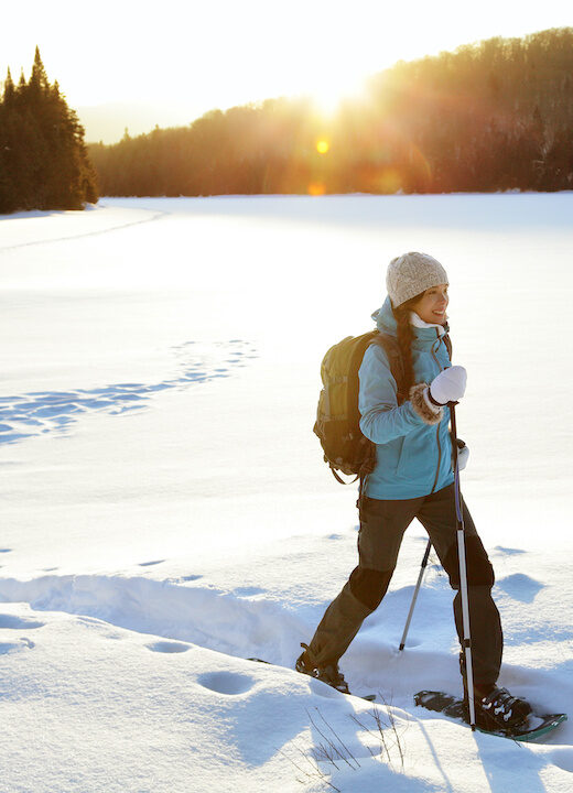 Winter hiking sport activity woman snowshoeing