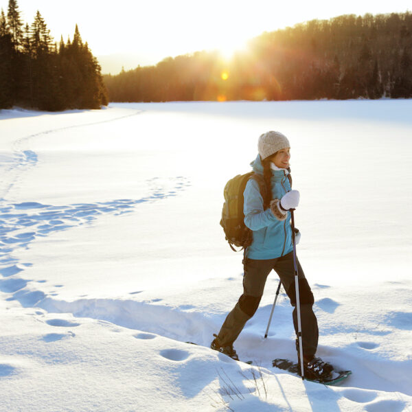 Winter hiking sport activity woman snowshoeing